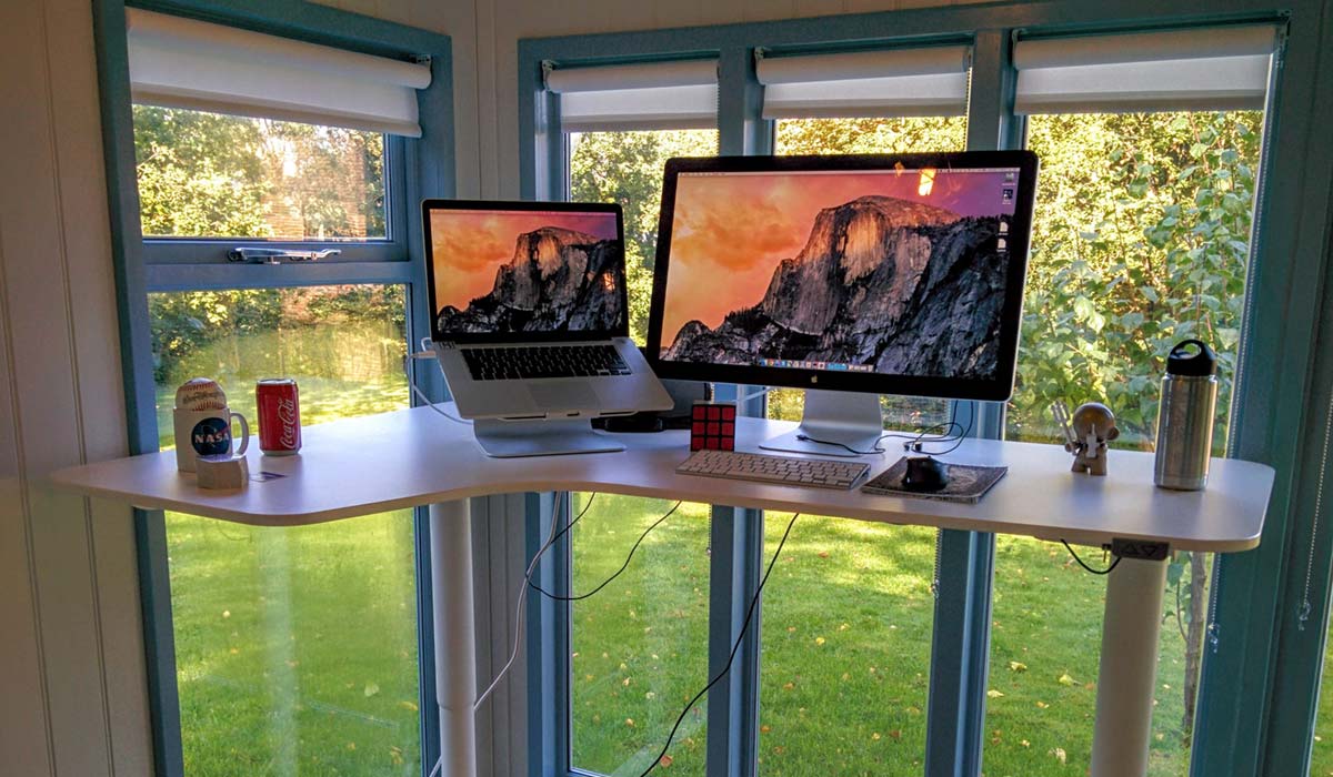 A photo of an iMac on a desk in a shed in the garden