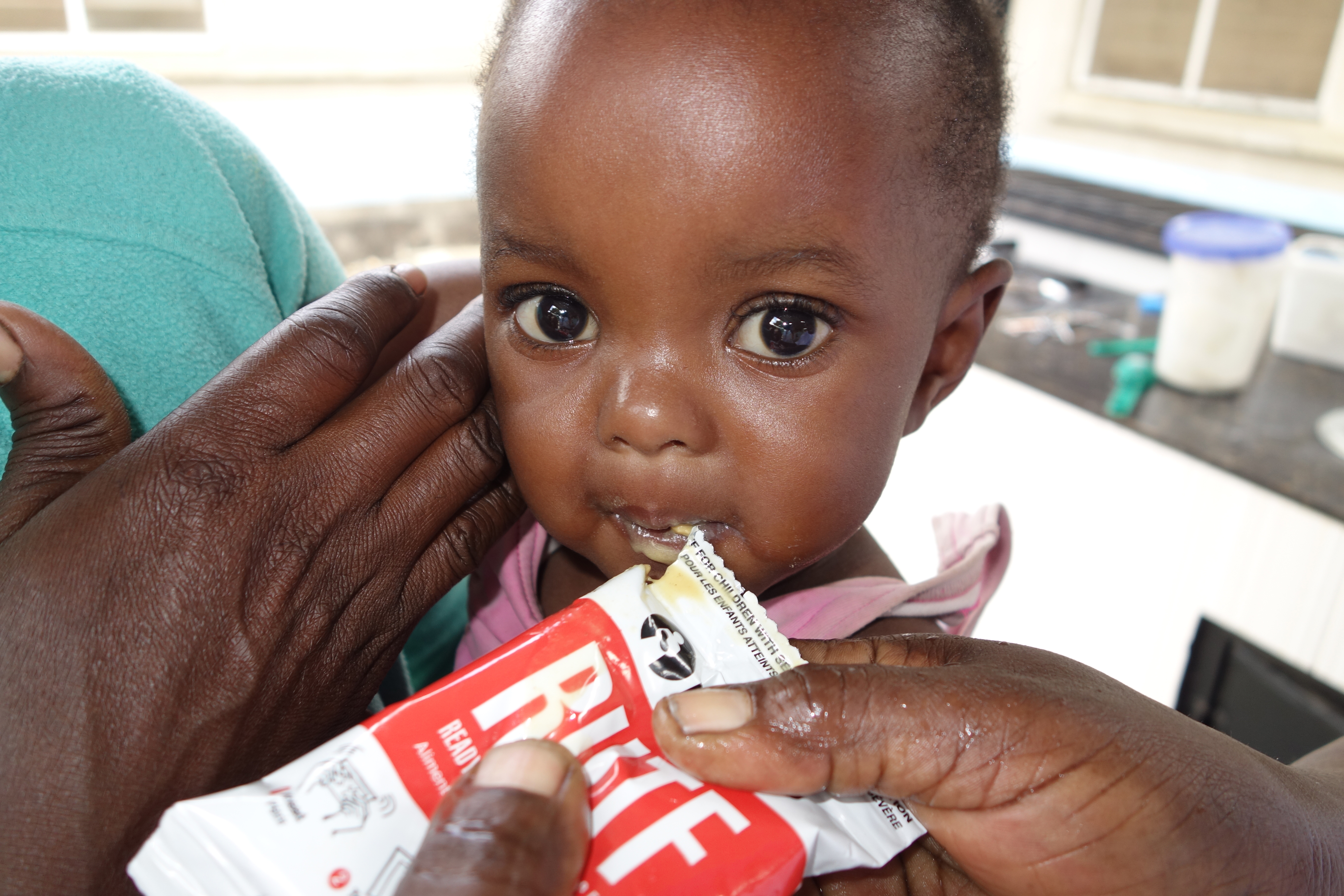 A child eating a RUTF packet